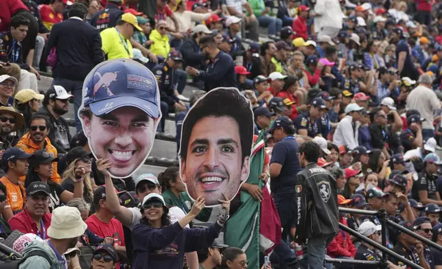 Fans cheer for Red Bull driver Sergio Perez of Mexico and Ferrari driver Carlos Sainz of Spain before the start of the Formula One Mexico Grand Prix auto race at the Hermanos Rodriguez racetrack in Mexico City, Sunday, Oct. 27, 2024. (AP Photo/Fernando Llano)