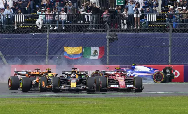 RB driver Yuki Tsunoda of Japan, back, crashes during the Formula One Mexico Grand Prix auto race at the Hermanos Rodriguez racetrack in Mexico City, Sunday, Oct. 27, 2024. (AP Photo/Moises Castillo)