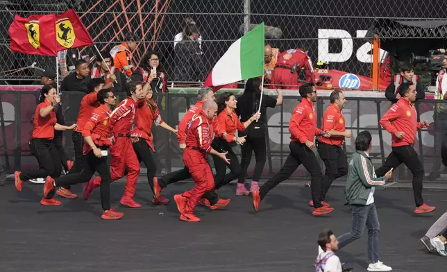 Ferrari team members celebrate after Carlos Sainz of Spain won the Formula One Mexico Grand Prix auto race at the Hermanos Rodriguez racetrack in Mexico City, Sunday, Oct. 27, 2024. (AP Photo/Eduardo Verdugo)