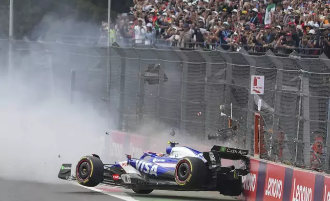 RB driver Yuki Tsunoda of Japan crashes during the Formula One Mexico Grand Prix auto race at the Hermanos Rodriguez racetrack in Mexico City, Sunday, Oct. 27, 2024. (AP Photo/Fernando Llano)