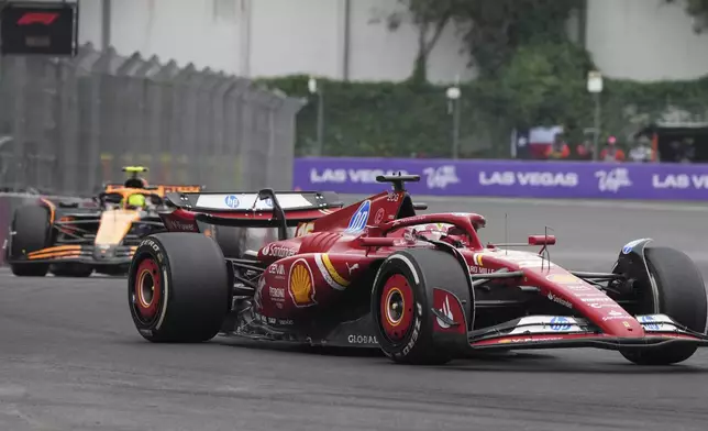 Charles Leclerc, of Monaco, steers his Ferrari followed by McLaren driver Lando Norris of Britain during the Formula One Mexico Grand Prix auto race at the Hermanos Rodriguez racetrack in Mexico City, Sunday, Oct. 27, 2024. (AP Photo/Fernando Llano)