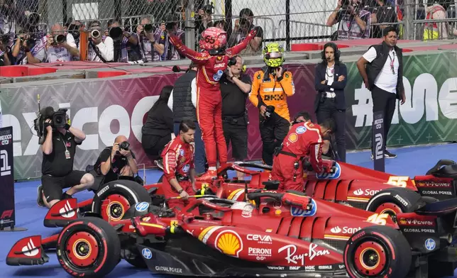 Ferrari driver Carlos Sainz of Spain celebrates after winning the Formula One Mexico Grand Prix auto race at the Hermanos Rodriguez racetrack in Mexico City, Sunday, Oct. 27, 2024. (AP Photo/Eduardo Verdugo)