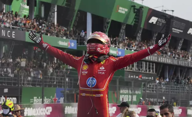 Ferrari driver Carlos Sainz of Spain celebrates after winning the Formula One Mexico Grand Prix auto race at the Hermanos Rodriguez racetrack in Mexico City, Sunday, Oct. 27, 2024. (AP Photo/Fernando Llano)