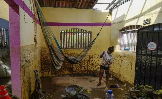 Yahaira Garcia, 32, cleans her damaged house after Hurricane John passed through Coyuca de Benitez, Guerrero state, Mexico, Monday, Sept. 30, 2024. (AP Photo/Felix Marquez)