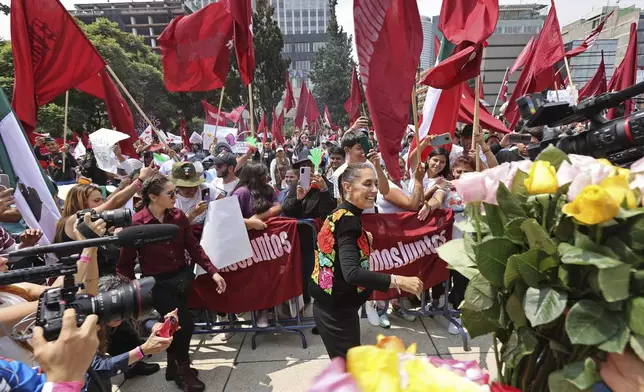 FILE - Former Mayor Claudia Sheinbaum greets supporters during a closing campaign rally for her presidential candidate bid to represent the ruling MORENA party, in Mexico City, Aug. 26, 2023. (AP Photo/Ginnette Riquelme, File)