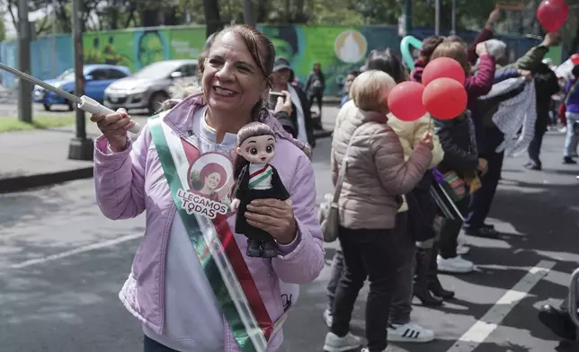 Supporters of Claudia Sheinbaum cheer as her vehicle passes on her inauguration day as she is taken to Congress to become Mexico's new president in Mexico City, Tuesday, Oct. 1, 2024. (AP Photo/Aurea Del Rosario)