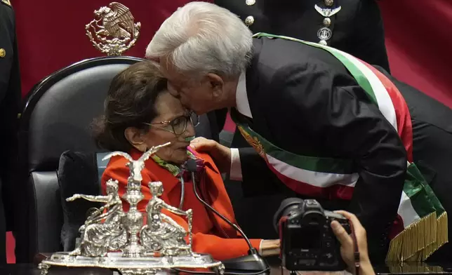 Outgoing President Andrés Manuel López Obrador kisses Ifigenia Martínez, president of the Chamber of Deputies, during the inauguration ceremony of Claudia Sheinbaum as Mexico's new president at Congress in Mexico City, Tuesday, Oct. 1, 2024. (AP Photo/Eduardo Verdugo)