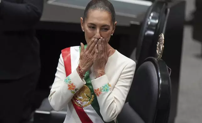 President Claudia Sheinbaum blows a kiss during her swearing-in ceremony as Mexico's new president at Congress in Mexico City, Tuesday, Oct. 1, 2024. (AP Photo/Fernando Llano)