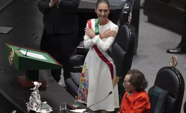 President Claudia Sheinbaum smiles after being sworn in as Mexico's president at Congress in Mexico City, Tuesday, Oct. 1, 2024. (AP Photo/Fernando Llano)