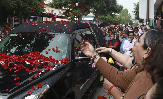 Supporters of slain Mayor Alejandro Arcos throw flowers during his funeral service, one week after he took office, in Chilpancingo, Guerrero state, Mexico, Monday, Oct. 7, 2024. (AP Photo/Alejandrino Gonzalez)