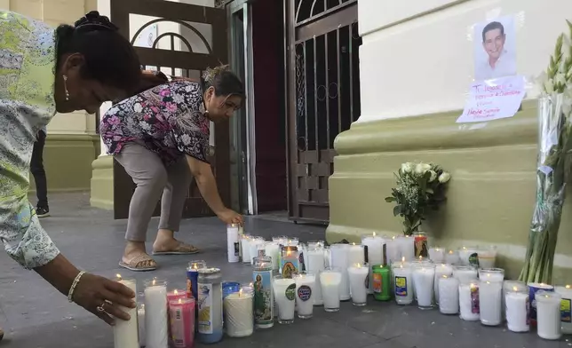 Supporters of slain Mayor Alejandro Arcos place candles and flowers at the entrance of the municipal building one week after he took office in Chilpancingo, Mexico, Monday, Oct. 7, 2024. (AP Photo/Alejandrino Gonzalez)