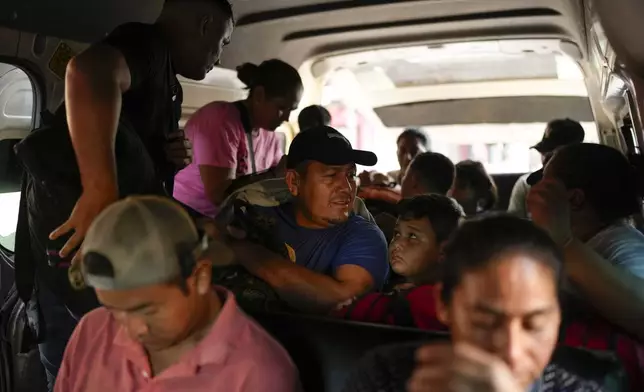 Honduran migrant Luis Alonso Valle, center, sits in a car on his to Tapachula from Ciudad Hidalgo, Mexico, after crossing the Suchiate River with his family from Guatemala, Monday, Oct. 28, 2024. (AP Photo/Matias Delacroix)