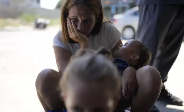 Venezuelan migrant Erika Arias waits with her family outside a shelter in Tapachula, Mexico, Sunday, Oct. 27, 2024. (AP Photo/Matias Delacroix)