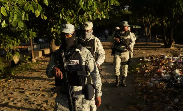 Police officers patrol an area next to Suchiate River in Ciudad Hidalgo, Mexico, on the border with Guatemala, Monday, Oct. 28, 2024. (AP Photo/Matias Delacroix)