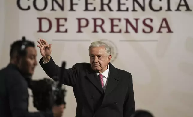 President Andres Manuel Lopez Obrador waves during his last morning press conference, or mañanera, at the National Palace in Mexico City, Monday, Sept. 30, 2024. (AP Photo/Fernando Llano)