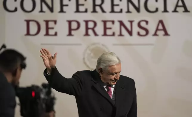 President Andres Manuel Lopez Obrador waves during his last morning press conference, or mañanera, at the National Palace in Mexico City, Monday, Sept. 30, 2024. (AP Photo/Fernando Llano)