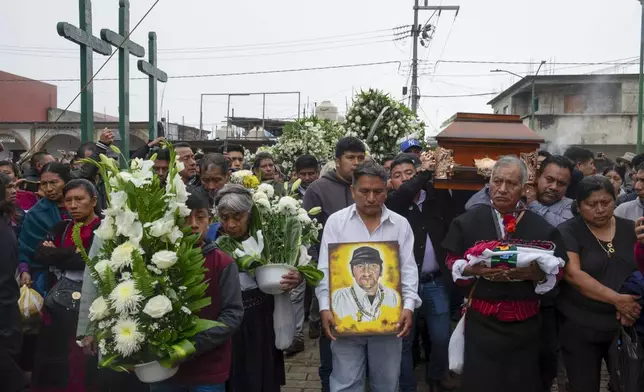 Residents take part in a funeral procession for slain Catholic priest and activist Marcelo Pérez, in San Andrés Larráinzar, Chiapas state, Mexico, Tuesday, Oct. 22, 2024. (AP Photo/Isabel Mateos)