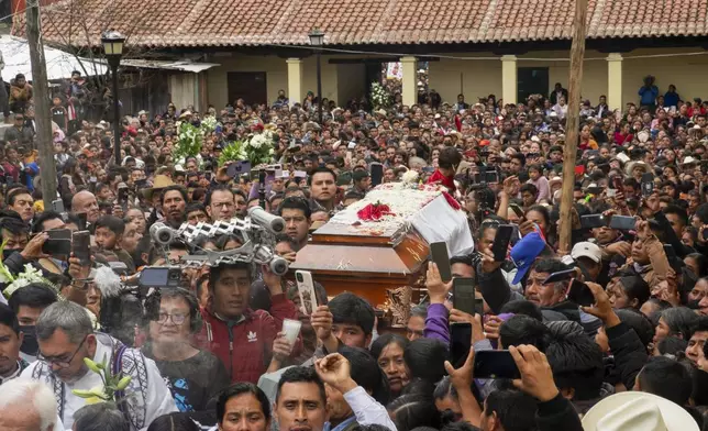 Residents accompany the coffin that contain the remains of slain Catholic priest and activist Marcelo Pérez, in San Andrés Larráinzar, Chiapas state, Mexico, Tuesday, Oct. 22, 2024. (AP Photo/Isabel Mateos)