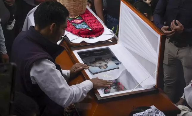 A neighbor pays his final respects to slain Catholic priest and activist Marcelo Pérez during his burial service at the church of San Andrés Larráinzar, Chiapas state, Mexico, Tuesday, Oct. 22, 2024. (AP Photo/Isabel Mateos)