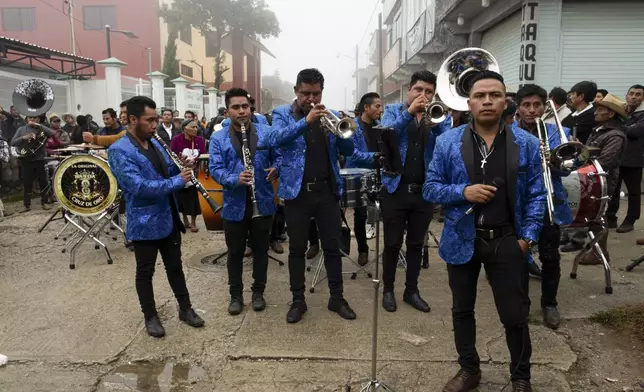 Musicians perform during a wake for slain Catholic priest and activist Marcelo Pérez, in San Andrés Larráinzar, Chiapas state, Mexico, Tuesday, Oct. 22, 2024. (AP Photo/Isabel Mateos)