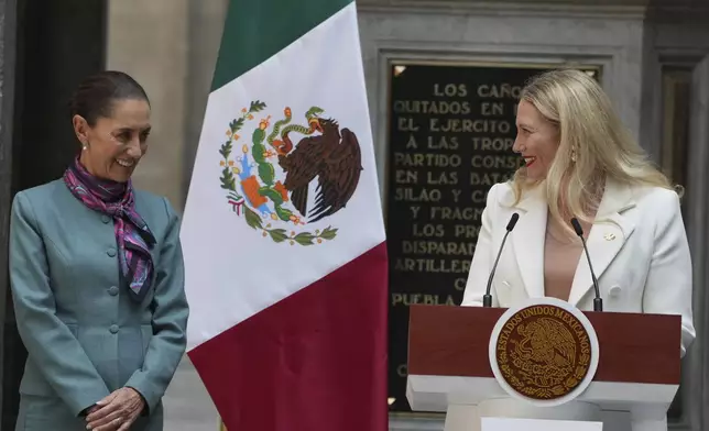 Mexican President Claudia Sheinbaum, left, stands with Sarah Bairstow, CEO of Mexico Pacific LLC, during a news conference at the National Palace in Mexico City, Tuesday, Oct. 15, 2024. (AP Photo/Fernando Llano)