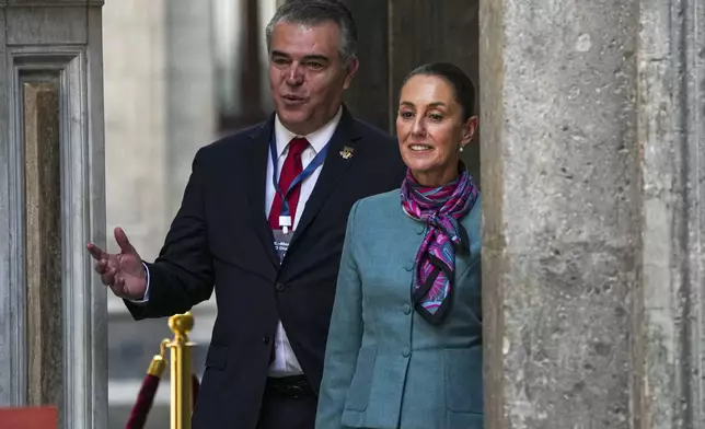 Mexican President Claudia Sheinbaum, right, and Mexican businessperson Francisco Cervantes arrive for a news conference at the National Palace in Mexico City, Tuesday, Oct. 15, 2024. (AP Photo/Fernando Llano)