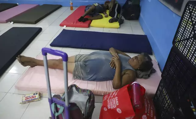 People rest in a refugee shelter prior to the arrival of Hurricane Milton, in Progreso, Yucatan state, Mexico, Monday, Oct. 7, 2024. (AP Photo/Martin Zetina)