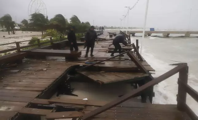 Yucatan State police inspect damage at the harbor from Hurricane Milton in Progreso, Yucatan state, Mexico, Tuesday, Oct. 8, 2024. (AP Photo/Martin Zetina)