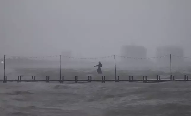 A sculpture of Poseidon stands in the ocean after the eye of Hurricane Milton passed off the coast of Progreso, Yucatan state, Mexico, Tuesday, Oct. 8, 2024. (AP Photo/Martin Zetina)