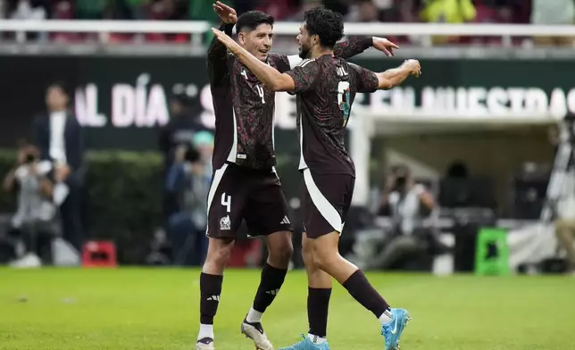 Mexico's Raúl Jiménez, right, is congratulated by Edson Álvarez after scoring his side's opening goal against the United States during an international friendly soccer match at Akron Stadium in Guadalajara, Mexico, Tuesday, Oct. 15, 2024. (AP Photo/Eduardo Verdugo)