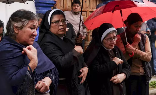 People gather around an altar where Catholic priest Marcelo Perez was killed in an armed attack after attending mass at a church in San Cristobal de las Casas, Chiapas state, Mexico, Sunday, Oct. 20, 2024. (AP Photo/Isabel Mateos)