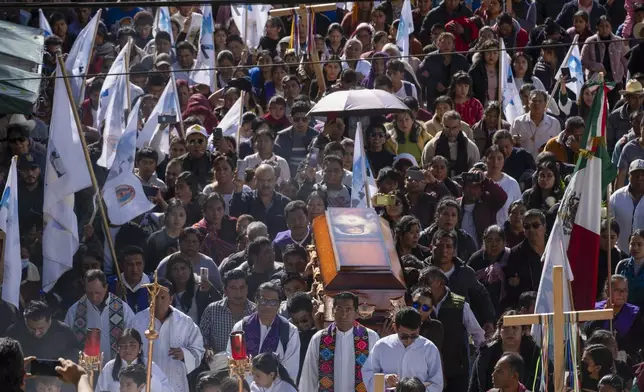 People carry the coffin of Catholic priest Marcelo Perez, who was killed in San Cristobal de las Casas, Chiapas state, Mexico, Sunday, Oct. 20, 2024. (AP Photo/Isabel Mateos)