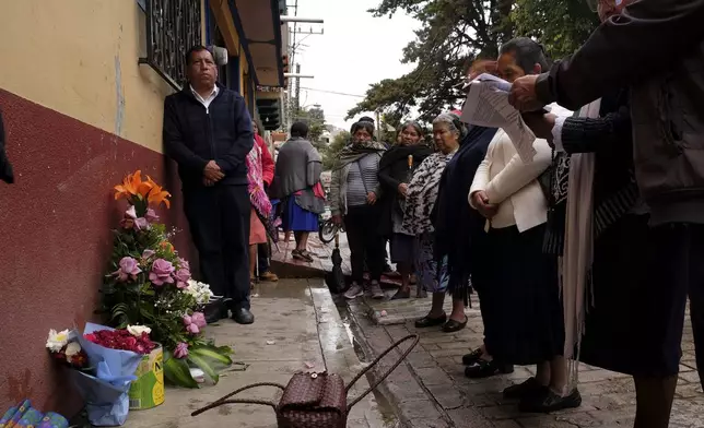 People gather around an altar where Catholic priest Marcelo Perez was killed in an armed attack after attending mass at a church in San Cristobal de las Casas, Chiapas state, Mexico, Sunday, Oct. 20, 2024. (AP Photo/Isabel Mateos)