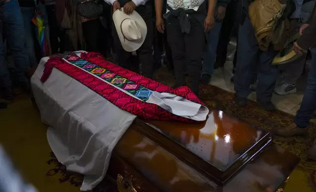 A tunic lies on the coffin of Catholic priest Marcelo Perez, who was killed in San Cristobal de las Casas, Chiapas state, Mexico, Sunday, Oct. 20, 2024. (AP Photo/Isabel Mateos)