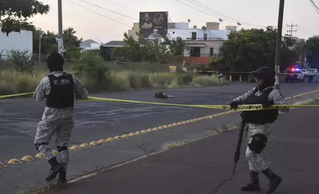 National Guards cordon off an area where a corpse lies on a street in Culiacan, Sinaloa state, Mexico, Monday, Oct. 14, 2024. (AP Photo)