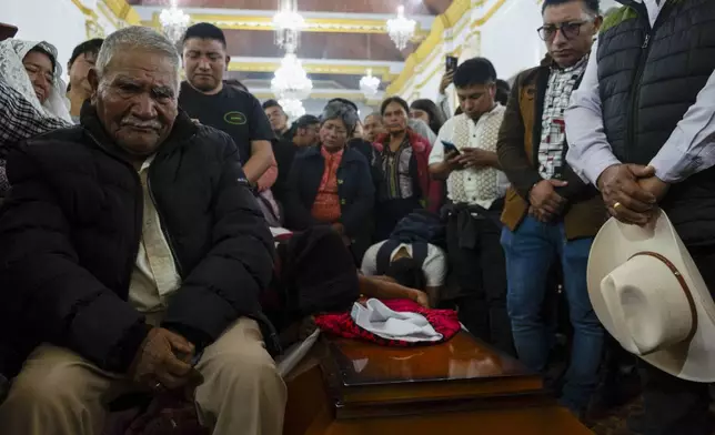 People attend a mass next to the coffin of Catholic priest Marcelo Perez, who was killed in San Cristobal de las Casas, Chiapas state, Mexico, Sunday, Oct. 20, 2024. (AP Photo/Isabel Mateos)