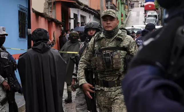 Soldiers, National Guards and police cordon off the site where Catholic priest Marcelo Perez was killed in an armed attack after attending mass at a church in San Cristobal de las Casas, Chiapas state, Mexico, Sunday, Oct. 20, 2024. (AP Photo/Isabel Mateos)