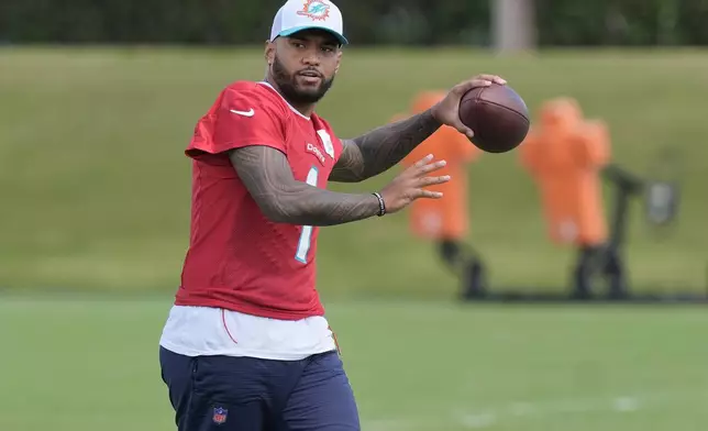 Miami Dolphins quarterback Tua Tagovailoa (1) aims the ball during a practice session at the team's training facility, Wednesday, Oct. 23, 2024, in Miami Gardens, Fla. (AP Photo/Marta Lavandier)