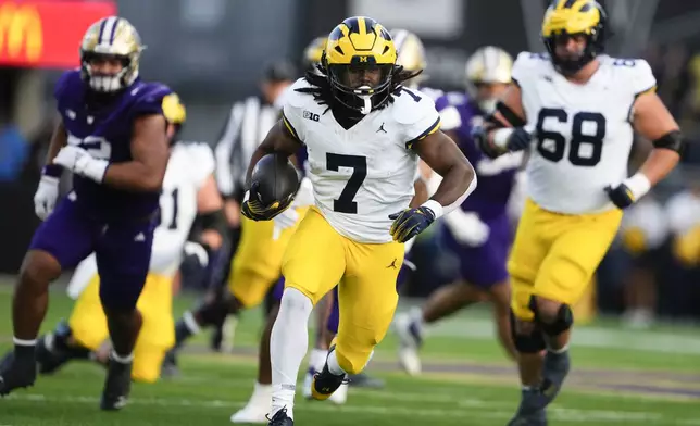 Michigan running back Donovan Edwards (7) runs for a touchdown against Washington during the first half of an NCAA college football game Saturday, Oct. 5, 2024, in Seattle. (AP Photo/Lindsey Wasson)