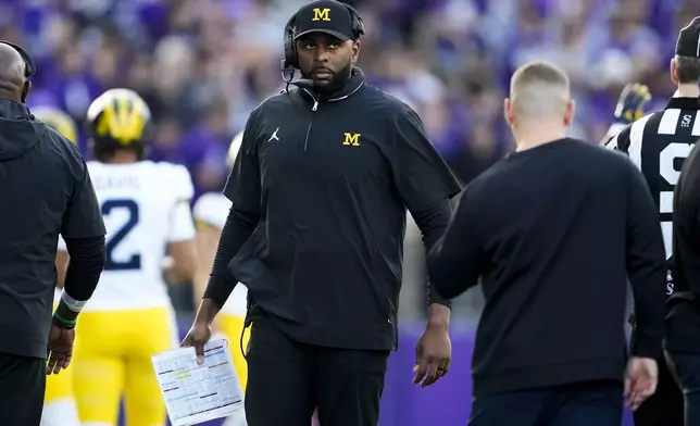 Michigan head coach Sherrone Moore walks on the sideline during the first half of an NCAA college football game against Washington, Saturday, Oct. 5, 2024, in Seattle. (AP Photo/Lindsey Wasson)