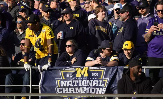 Michigan fans look on from the stands during the first half of an NCAA college football game between Washington and Michigan, Saturday, Oct. 5, 2024, in Seattle. (AP Photo/Lindsey Wasson)