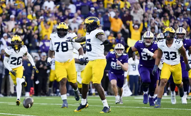 Michigan linebacker Ernest Hausmann (15) reacts after his team blocked a field goal attempt by Washington place kicker Grady Gross during the first half of an NCAA college football game Saturday, Oct. 5, 2024, in Seattle. (AP Photo/Lindsey Wasson)