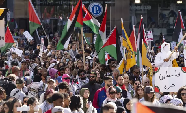 Demonstrators protest in support of the Palestinian people, Saturday, Oct. 5, 2024, in Toronto, days before the one-year anniversary of Hamas' attack in southern Israel and Israel's response to go to war on Hamas. (Arlyn McAdorey/The Canadian Press via AP)