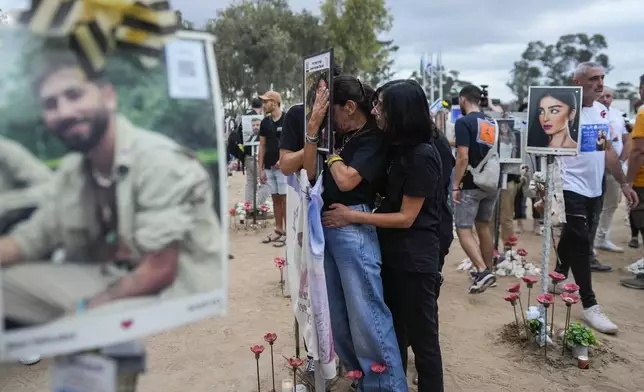 People visit the site of the Nova music festival, where hundreds of revelers were killed and abducted by Hamas and taken into Gaza, on the one-year anniversary of the attack, near Kibbutz Reim, southern Israel, Monday, Oct. 7, 2024. (AP Photo/Ohad Zwigenberg)