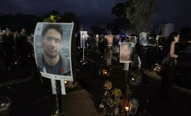 People visit the site of the Nova music festival, where hundreds of revelers were killed and abducted by Hamas and taken into Gaza, on the one-year anniversary of the attack, near Kibbutz Reim, southern Israel, Monday, Oct. 7, 2024. (AP Photo/Ariel Schalit)