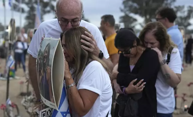 People visit the site of the Nova music festival, where hundreds of revelers were killed and abducted by Hamas and taken into Gaza, on the one-year anniversary of the attack, near Kibbutz Reim, southern Israel, Monday, Oct. 7, 2024. (AP Photo/Ariel Schalit)