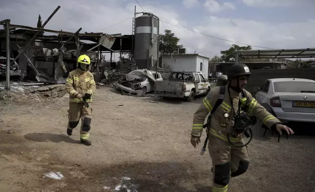 Emergency personnel respond after a rocket apparently fired from Gaza hits Kfar Chabad near Tel Aviv, Monday, Oct. 7, 2024. (AP Photo/Oded Balilty)