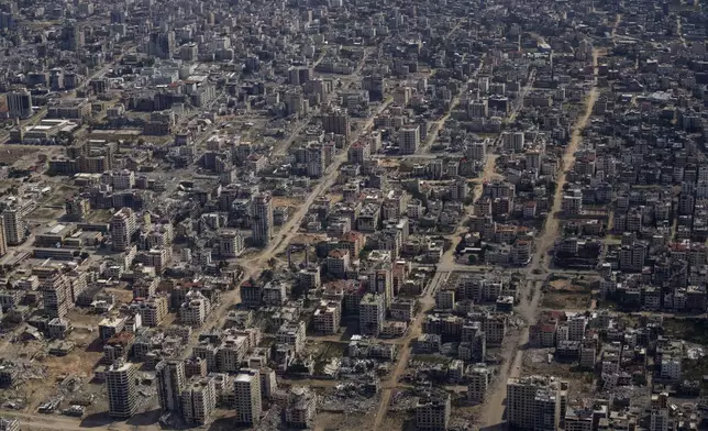 FILE - Destroyed buildings are seen through the window of an airplane from the U.S. Air Force overflying the Gaza Strip, Thursday, March 14, 2024. (AP Photo/Leo Correa, File)