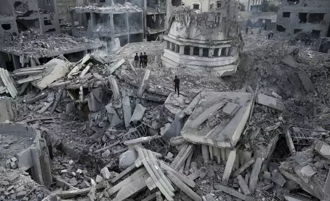 FILE - Palestinians inspect the rubble of the Yassin Mosque destroyed after it was hit by an Israeli airstrike at Shati refugee camp in Gaza City, early Monday, Oct. 9, 2023. Israel's military battled to drive Hamas fighters out of southern towns and seal its borders Monday as it pounded the Gaza Strip. (AP Photo/Adel Hana, File)