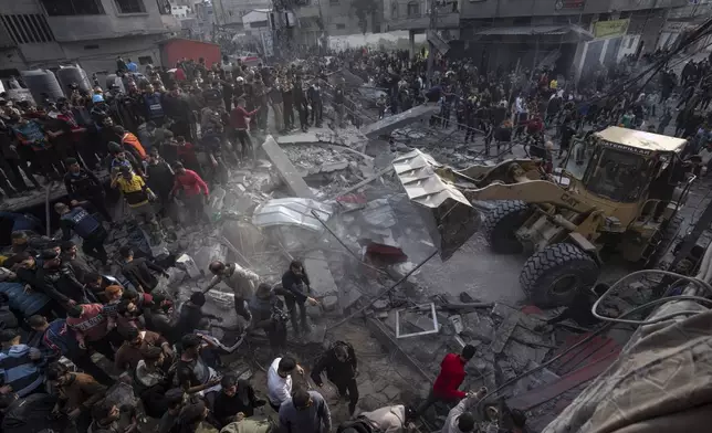 FILE - Palestinians search for bodies and survivors in the rubble of a residential building destroyed in an Israeli airstrike, in Rafah southern Gaza Strip, Wednesday, Dec. 20, 2023. (AP Photo/Fatima Shbair, File)